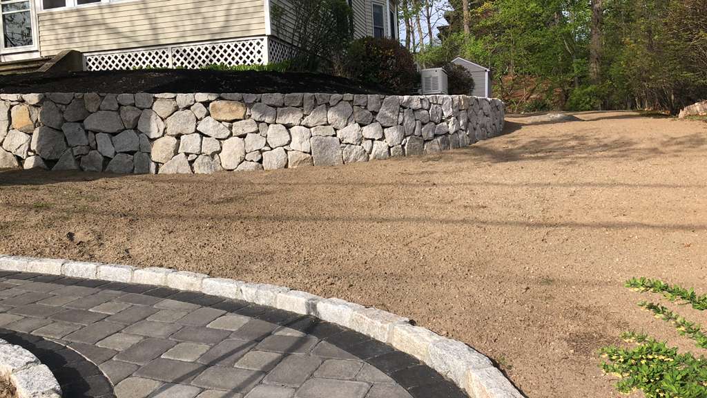 Stone wall with circular paver patio