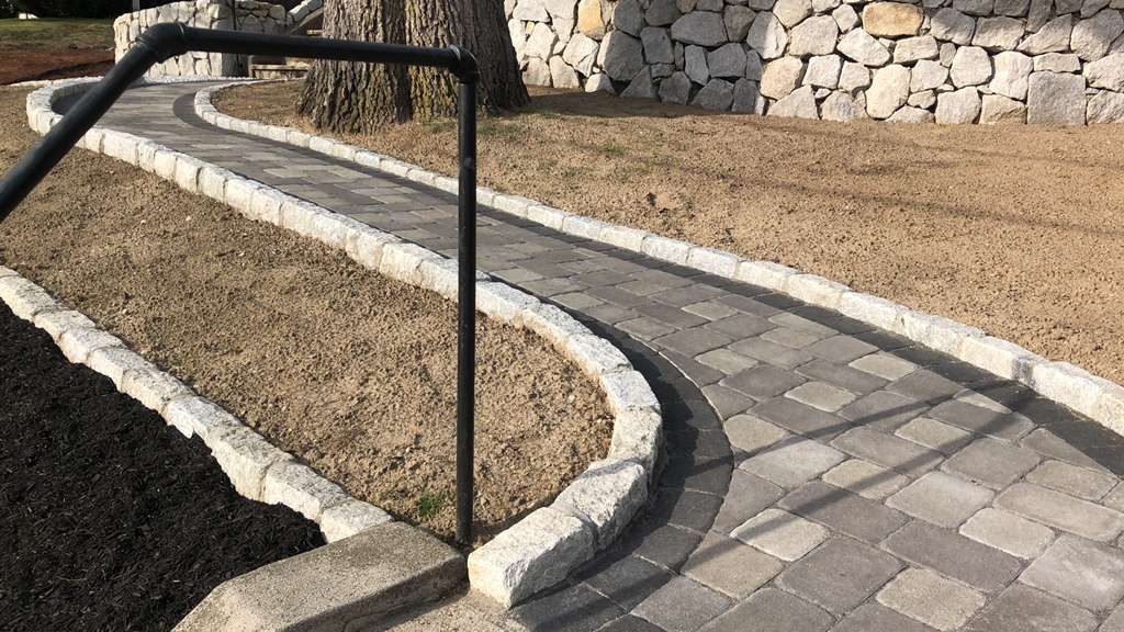 Cobblestone path with iron railing