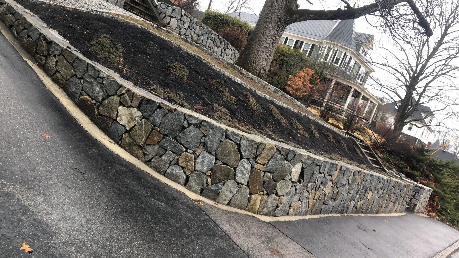 Long retaining wall along driveway