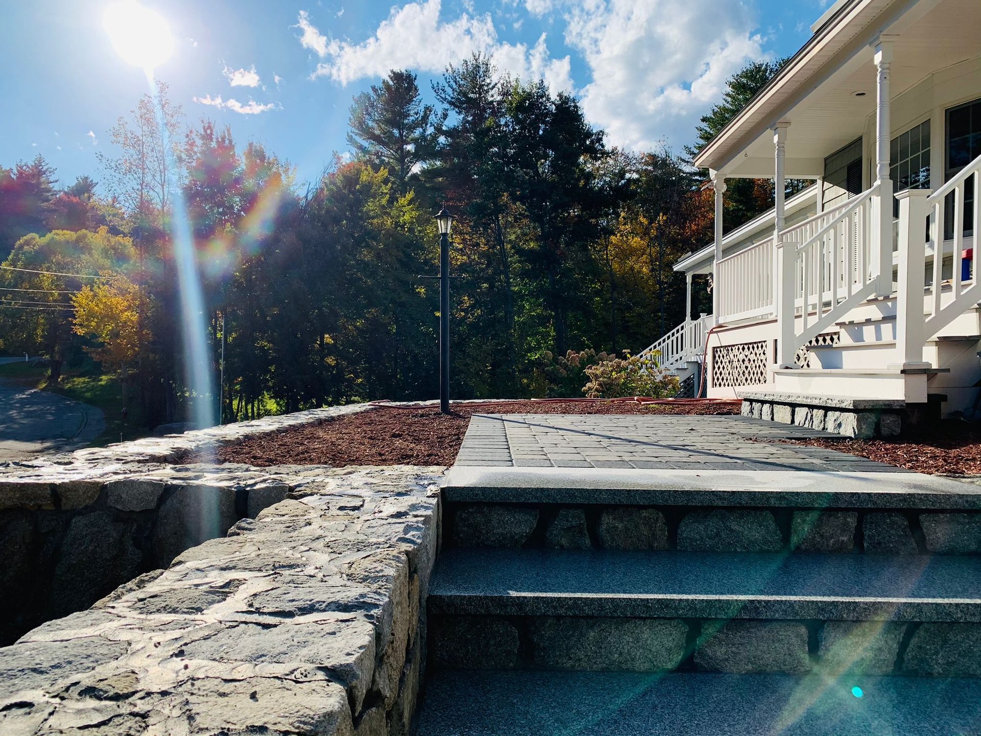 Paver patio with granite steps and stone retaining wall